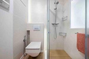 a white bathroom with a toilet and a shower at II-II Hub Luxury New Apartments in Barcelona