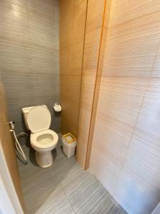 a small bathroom with a toilet and a shower at Baan Hall Hostel in Khon Kaen