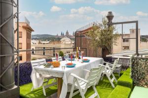 a white table and chairs on a balcony at II-II Hub Luxury New Apartments in Barcelona