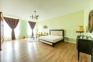a bedroom with a bed and a wooden floor at CozyFlat in the central Arad in Arad