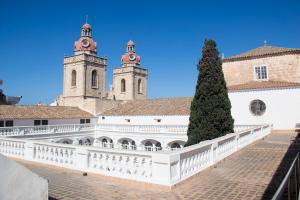 休达德亚Grupoandria El Claustre de Ciutadella - HOSPEDERIA的两座塔楼楼前的白色围栏