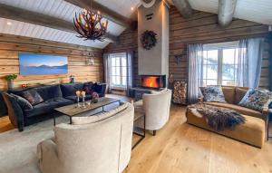 a living room with couches and a fireplace at Amazing Home In Rauland With Wifi in Rauland