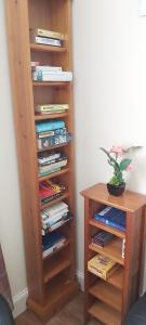 a book shelf filled with books next to a table at Newmarket in Stornoway