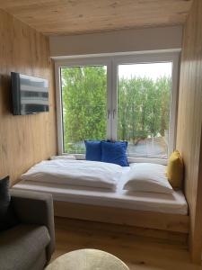 a bed in a room with a large window at Livero Apartments in Sankt Pölten