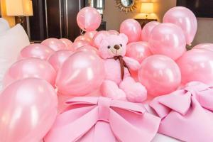a pink teddy bear sitting in a bunch of balloons at The Yangtze Boutique Shanghai in Shanghai