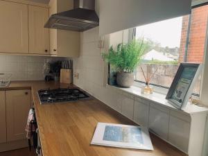 a kitchen with a book on a counter with a window at Avon View in Salisbury