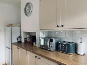 a kitchen with a counter with a microwave and a refrigerator at Avon View in Salisbury