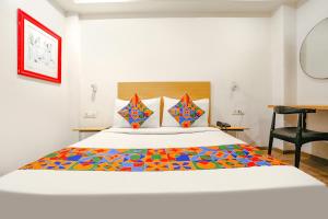 a bedroom with a large bed with a colorful blanket at Via Blusky in New Delhi
