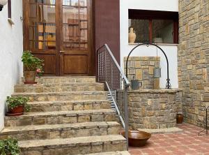 a set of stairs in front of a house with a door at Casa Rural Frigols in Chella