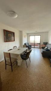 a large living room with a table and chairs at flat Holiday friend group or family near beach center blasco ibanez in Valencia