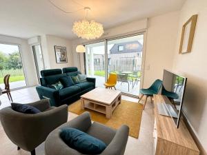 un soggiorno con divano, sedie e tavolo di Grand appartement neuf de standing – Top Cosy a Larmor-Plage