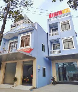 a blue building with a sign on it at KHÁCH SẠN VĂN KHANG in Bạc Liêu