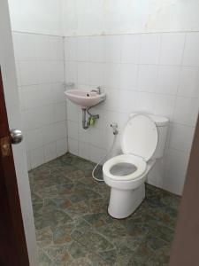 a bathroom with a toilet and a sink at Lumbung Sari Home Stay in Amed