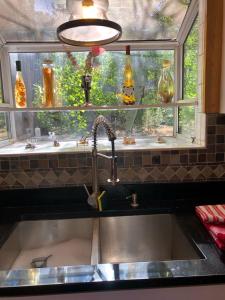 a kitchen sink with a window above it with a sink at Tahoe Cottage perfect for couples and outdoor enthusiasts in South Lake Tahoe