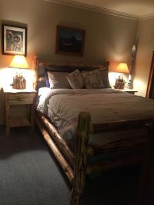 a bedroom with a wooden bed with two night stands at Tahoe Cottage perfect for couples and outdoor enthusiasts in South Lake Tahoe