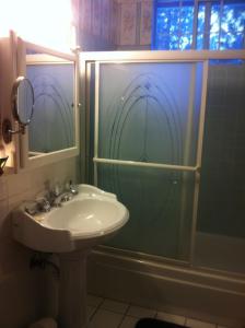 a bathroom with a sink and a glass shower at Tahoe Cottage perfect for couples and outdoor enthusiasts in South Lake Tahoe +40 photos