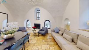 a living room with a couch and a table at VILLA MAMILLA - Boutique suites in Jerusalem