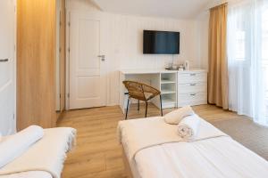 Posteľ alebo postele v izbe v ubytovaní Apartamenty Defala i Strefa Relaksu Natural Touch