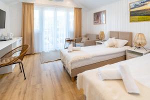Posteľ alebo postele v izbe v ubytovaní Apartamenty Defala i Strefa Relaksu Natural Touch