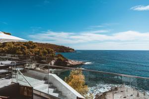 a view of the ocean from a hotel balcony at Apollo Resort in Agia Marina Aegina