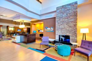 a lobby with purple chairs and a fireplace at Fairfield Inn and Suites by Marriott Durham Southpoint in Durham