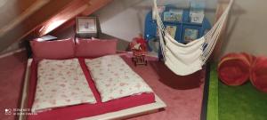 a toy bedroom with a bed and a hammock at Durchreisestop mit Kinder am außergewöhnlichen Spitzboden mit Autobetten und Bad ,Küche im Souterain in Deining