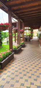 un patio con flores y plantas en un edificio en Hotel Yarus, en Ploieşti