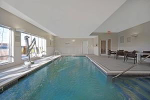a swimming pool with blue water in a building at TownePlace Suites by Marriott Fall River Westport in Lakeside