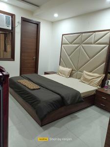 um quarto com uma cama grande num quarto em OYO Hotel Daffodils Near Aravali Biodiversity Park em Gurgaon