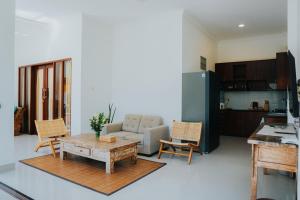 a living room with a couch and a table at Villa Gading 2 in Ubud
