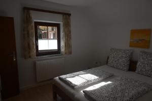 a bedroom with a bed and a window at Ferienhaus Humer in Altmünster