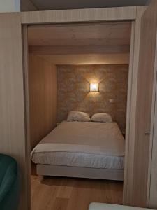 a small bedroom with a bed in a room at Renovated fully equipped studio for 2 to 4 pers in La Ciotat