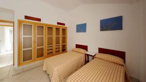 a room with two beds and a cabinet at Adosado La Guancha in San Miguel de Abona