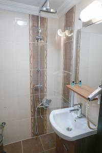 a bathroom with a shower and a sink at My Way Tera Butik Otel in Adalar