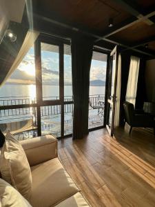 a living room with a couch and a view of the ocean at Noy Land Resort in Sevan