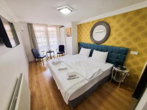 a bedroom with a large bed and a mirror at My Way Tera Butik Otel in Adalar