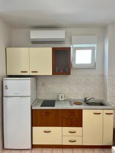 a kitchen with a white refrigerator and a sink at City Place in Split