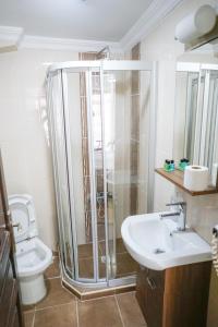 a bathroom with a shower and a sink and a toilet at My Way Tera Butik Otel in Adalar