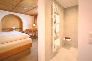 a bedroom with a bed and a dining room at Haus Barbarahof in Altenmarkt im Pongau