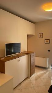 an office with a desk with a tv on top of it at La dolce vita (1) in Bergamo