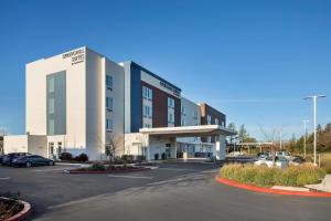 a building with a parking lot in front of it at SpringHill Suites by Marriott West Sacramento in West Sacramento