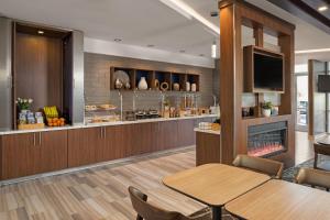 a dining room with a table and a fireplace at SpringHill Suites by Marriott West Sacramento in West Sacramento