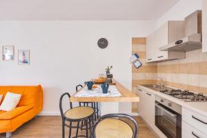 a kitchen with a table and chairs and a couch at Casa di Gino` by BarbarHouse in San Foca