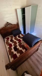 a wooden bed in a room with at Rasos kiemelis in Palanga