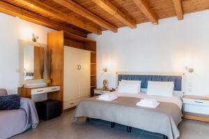 a bedroom with two beds and a mirror at Oula Maisonettes Suites in Kavos +91 photos