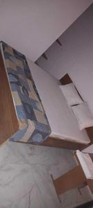a bed in a room with a mattress with a pattern at OYO Jsb Royal Inn in Muzaffarnagar