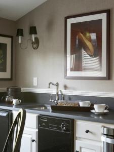 a kitchen with a sink and a person in a painting at The White Hart in Salisbury