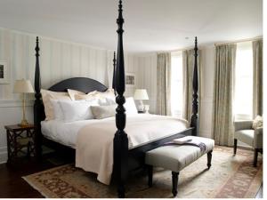 a bedroom with a large bed and a chair at The White Hart in Salisbury