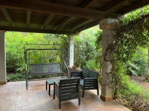 two benches and a table on a patio at Nisportino Domus in Rio nellʼElba