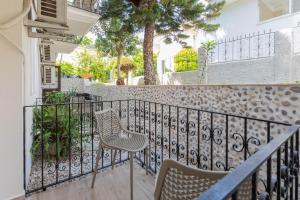 a balcony with two chairs and a fence at Bronze Hotel in Oludeniz